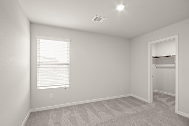 17832 Lionheart Rd, Conroe, TX 77306 - unfurnished bedroom with light colored carpet, a spacious closet, baseboards, and a closet