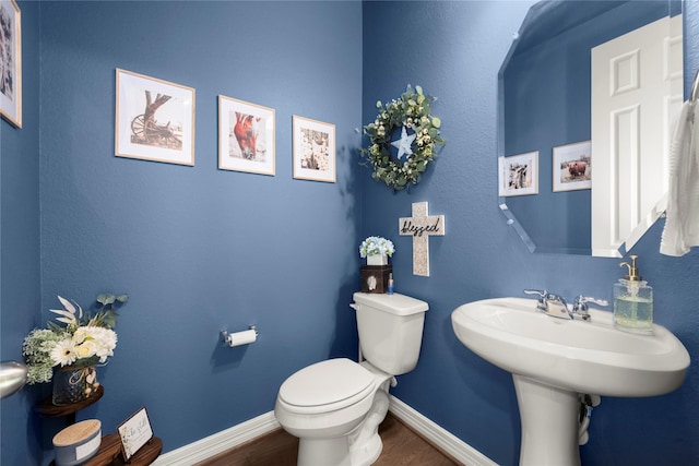 17010 Bainham Forest Trl, Hockley, TX 77447 - bathroom with toilet, wood finished floors, and baseboards