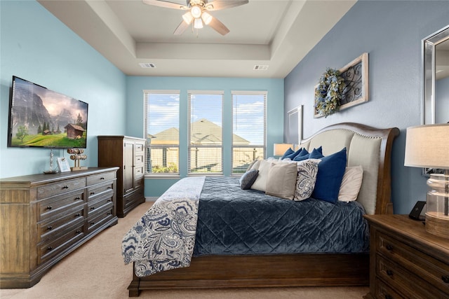 17010 Bainham Forest Trl, Hockley, TX 77447 - bedroom with light carpet, a tray ceiling, and a ceiling fan
