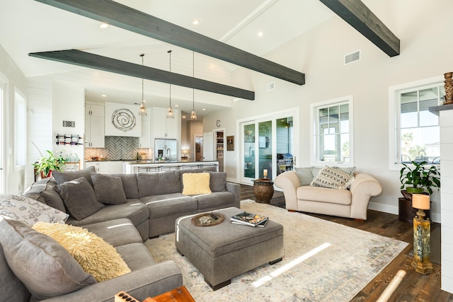 living area with plenty of natural light, beamed ceiling, dark wood-style flooring, visible vents, and recessed lighting