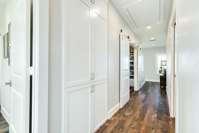 hall with attic access, baseboards, recessed lighting, and dark wood-type flooring