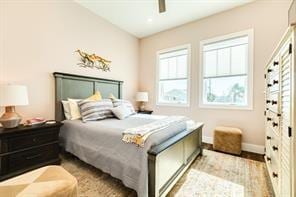 bedroom with baseboards, a ceiling fan, and wood finished floors