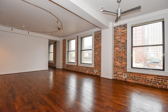 915 Franklin St Unit 4A, Houston, TX 77002 - spare room with brick wall, a ceiling fan, plenty of natural light, wood finished floors, and baseboards