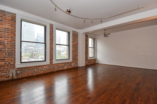915 Franklin St Unit 4A, Houston, TX 77002 - unfurnished room with brick wall, wood finished floors, and baseboards