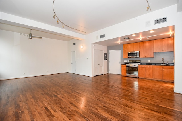 915 Franklin St Unit 4A, Houston, TX 77002 - kitchen featuring appliances with stainless steel finishes, open floor plan, dark wood-type flooring, and dark countertops