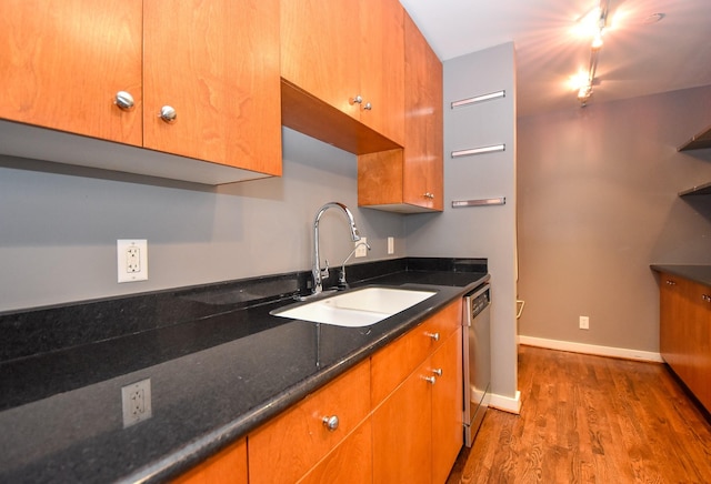 915 Franklin St Unit 4A, Houston, TX 77002 - kitchen with a sink, stainless steel dishwasher, wood finished floors, track lighting, and baseboards