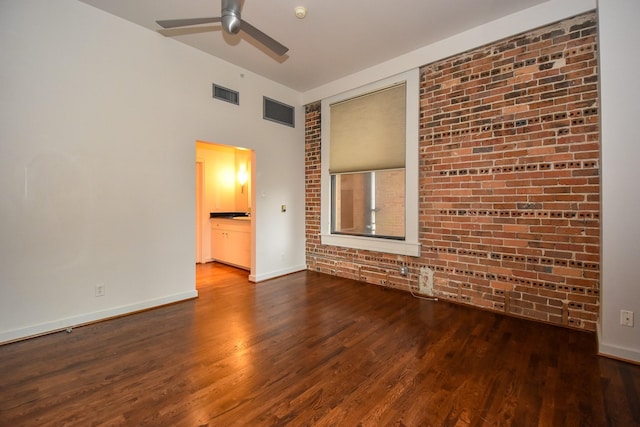 915 Franklin St Unit 4A, Houston, TX 77002 - unfurnished room featuring wood finished floors, brick wall, a ceiling fan, and baseboards
