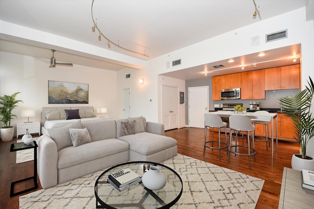 915 Franklin St Unit 4A, Houston, TX 77002 - living area featuring dark wood-style floors and rail lighting