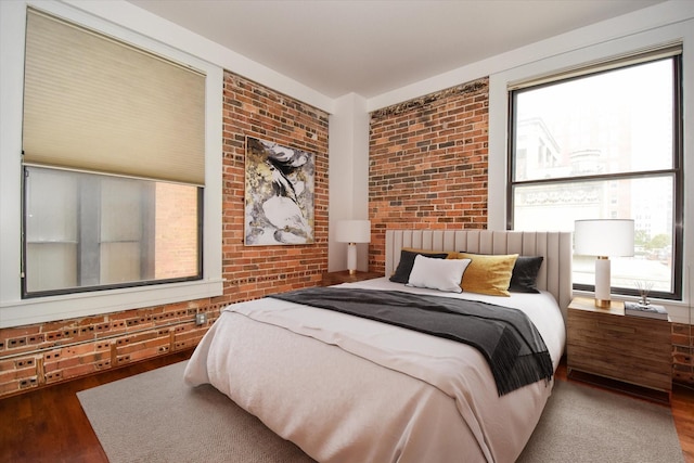 915 Franklin St Unit 4A, Houston, TX 77002 - bedroom with wood finished floors and brick wall