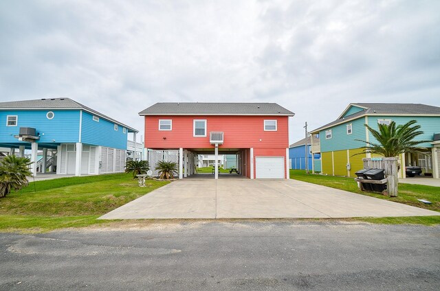3346 Pirates Cv, Crystal Beach, TX 77650 - raised beach house featuring a carport, driveway, a front yard, and a garage