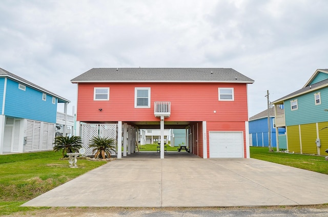 3346 Pirates Cv, Crystal Beach, TX 77650 - view of front of home with concrete driveway, a carport, roof with shingles, a front yard, and a garage