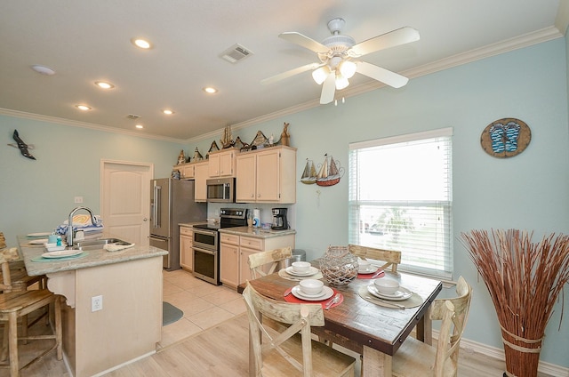 3346 Pirates Cv, Crystal Beach, TX 77650 - kitchen with crown molding, a sink, ceiling fan, stainless steel appliances, and visible vents