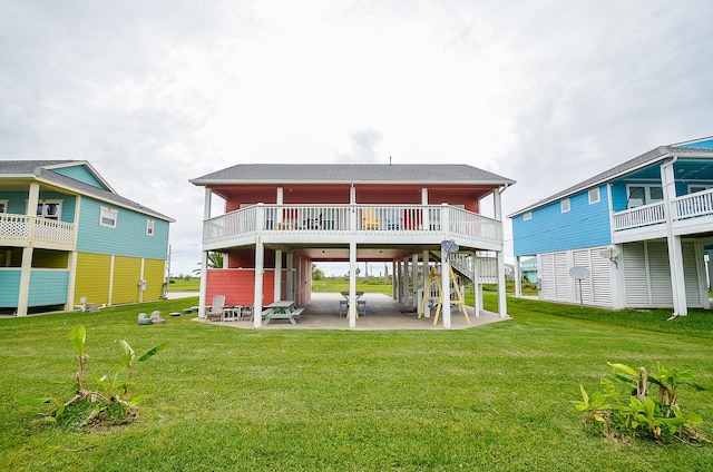 3346 Pirates Cv, Crystal Beach, TX 77650 - back of property featuring a lawn and a patio