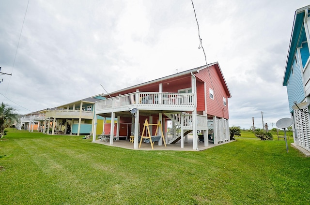 3346 Pirates Cv, Crystal Beach, TX 77650 - back of house featuring a wooden deck, a lawn, a patio, and stairway