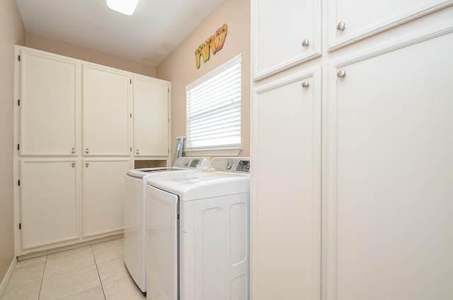 3346 Pirates Cv, Crystal Beach, TX 77650 - washroom with light tile patterned floors, cabinet space, and independent washer and dryer