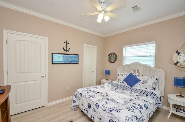 3346 Pirates Cv, Crystal Beach, TX 77650 - bedroom featuring baseboards, crown molding, visible vents, and light wood finished floors