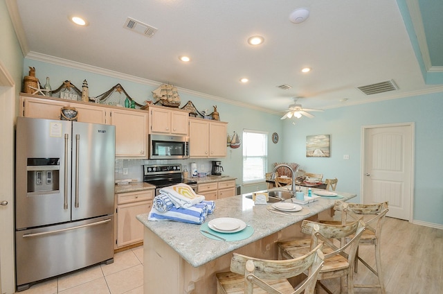 3346 Pirates Cv, Crystal Beach, TX 77650 - kitchen featuring visible vents, crown molding, stainless steel appliances, and a sink