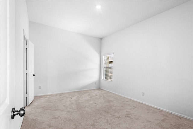 carpeted spare room with baseboards