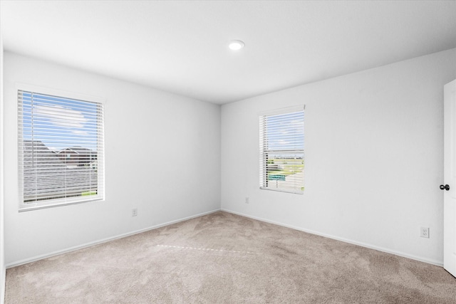 carpeted empty room featuring baseboards and recessed lighting
