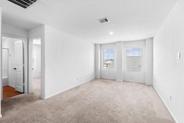 unfurnished bedroom with baseboards, visible vents, and carpet floors