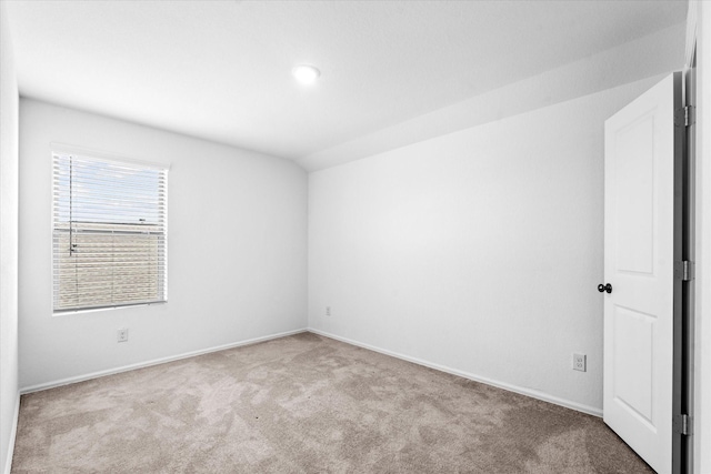 carpeted empty room featuring baseboards, vaulted ceiling, and recessed lighting