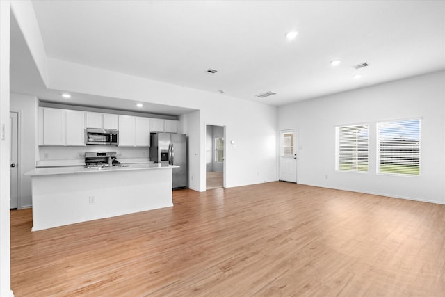 unfurnished living room featuring recessed lighting, light wood-style floors, and visible vents
