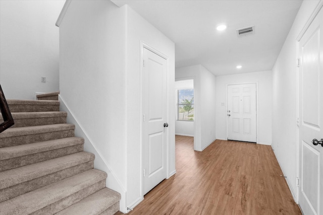 interior space with recessed lighting, wood finished floors, visible vents, and baseboards