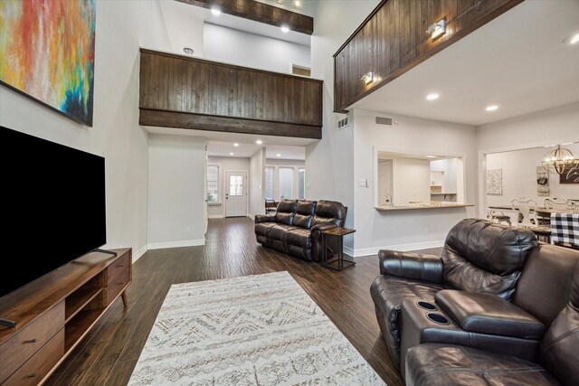 12692 Briar Patch Rd, Houston, TX 77077 - living room featuring visible vents, baseboards, a high ceiling, and dark wood-style flooring