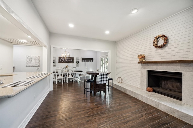 12692 Briar Patch Rd, Houston, TX 77077 - dining space with dark wood-style floors, baseboards, recessed lighting, brick wall, and a fireplace