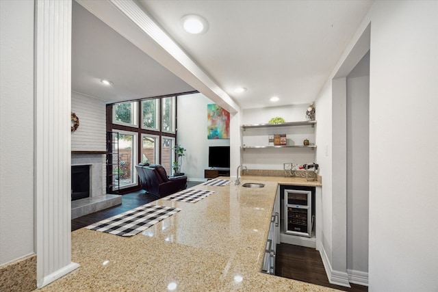 12692 Briar Patch Rd, Houston, TX 77077 - living room with a tile fireplace, baseboards, wet bar, wine cooler, and recessed lighting
