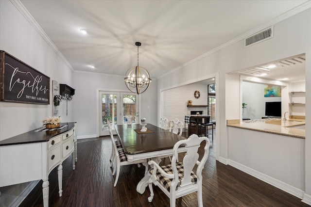 12692 Briar Patch Rd, Houston, TX 77077 - dining area featuring visible vents, dark wood-type flooring, crown molding, baseboards, and a chandelier