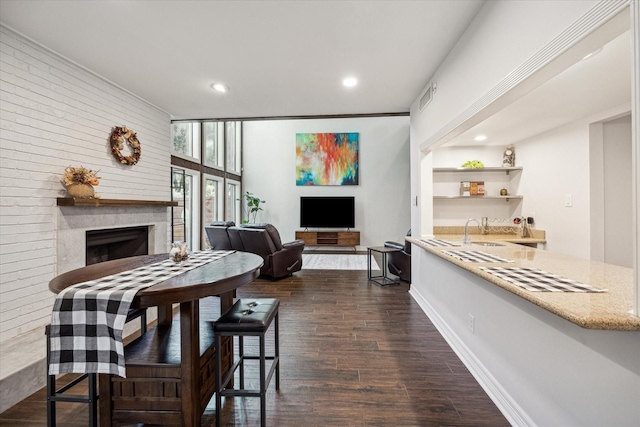 12692 Briar Patch Rd, Houston, TX 77077 - dining area with dark wood-style floors, baseboards, visible vents, recessed lighting, and a fireplace