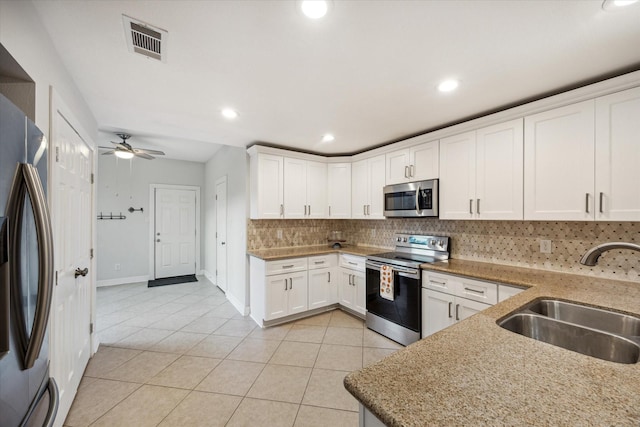 12692 Briar Patch Rd, Houston, TX 77077 - kitchen with tasteful backsplash, a sink, light tile patterned floors, stainless steel appliances, and visible vents