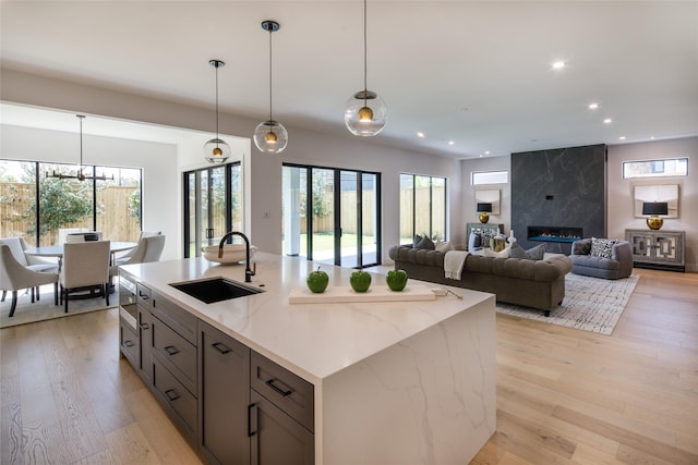 2239 Colquitt St, Houston, TX 77098 - kitchen featuring a sink, light wood finished floors, pendant lighting, and recessed lighting