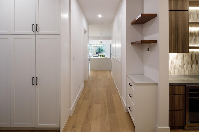 2239 Colquitt St, Houston, TX 77098 - hallway with beverage cooler, recessed lighting, and light wood-style flooring