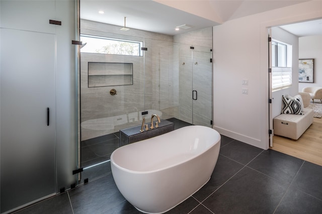 2239 Colquitt St, Houston, TX 77098 - full bathroom with baseboards, tile patterned flooring, a soaking tub, and a shower stall
