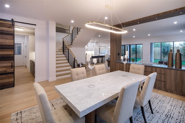 2239 Colquitt St, Houston, TX 77098 - dining room featuring a barn door, recessed lighting, stairs, and light wood-style flooring