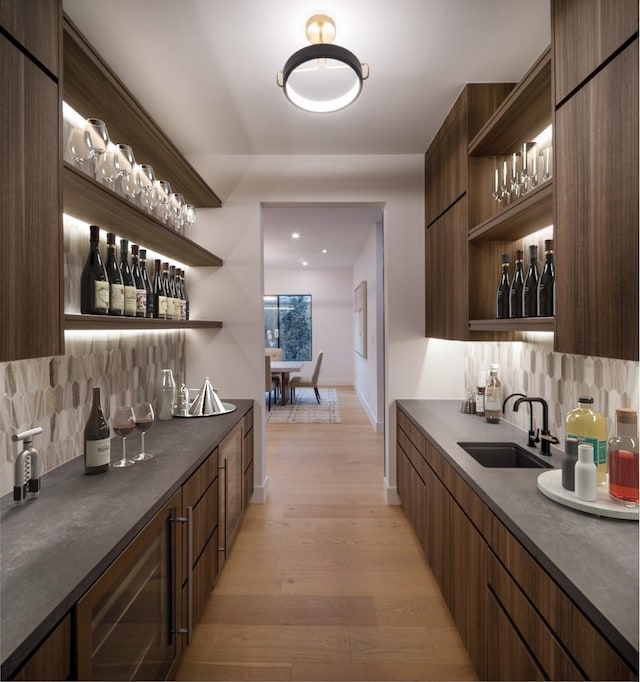 2239 Colquitt St, Houston, TX 77098 - bar with a sink, tasteful backsplash, light wood-style floors, and wet bar
