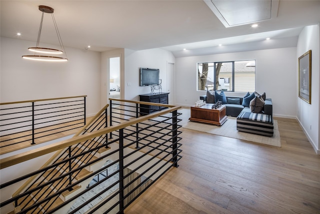 2239 Colquitt St, Houston, TX 77098 - stairs featuring recessed lighting, attic access, baseboards, and wood finished floors