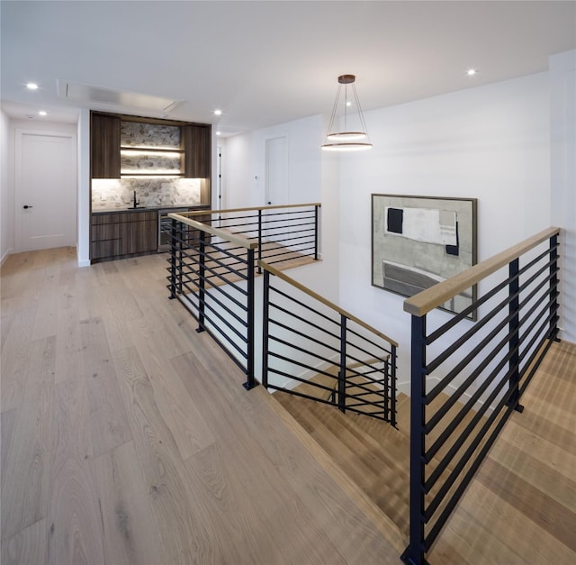 2239 Colquitt St, Houston, TX 77098 - stairs featuring recessed lighting, attic access, baseboards, and wood finished floors