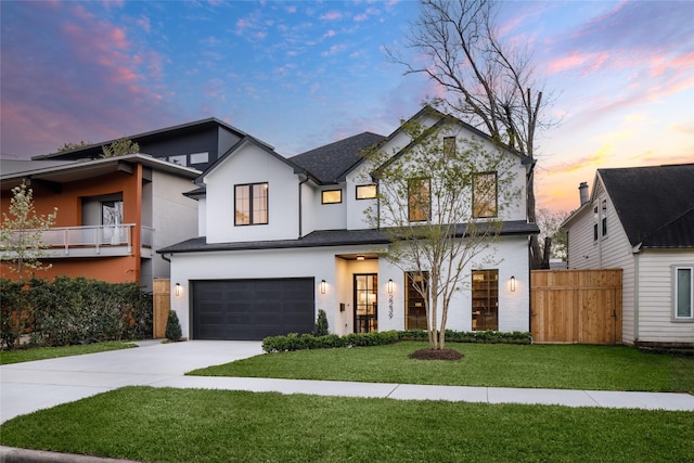 2239 Colquitt St, Houston, TX 77098 - view of front of home with fence, driveway, stucco siding, an attached garage, and a yard