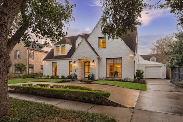 french country inspired facade featuring brick siding and driveway