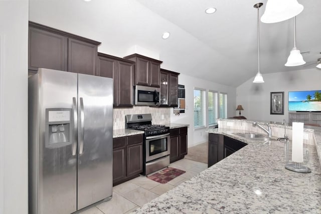 kitchen with tasteful backsplash, dark brown cabinets, a sink, stainless steel appliances, and lofted ceiling