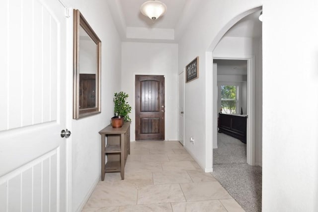 interior space with arched walkways and baseboards