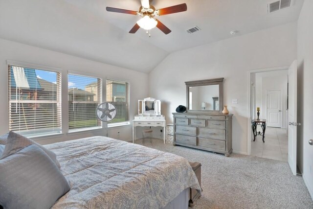 bedroom featuring vaulted ceiling, visible vents, carpet, and a ceiling fan
