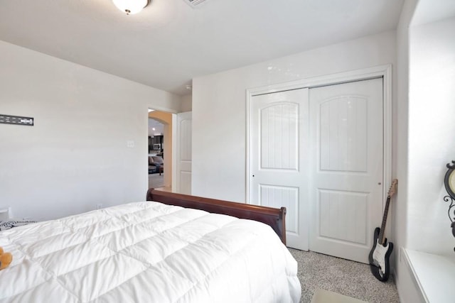 bedroom with arched walkways, a closet, and light carpet