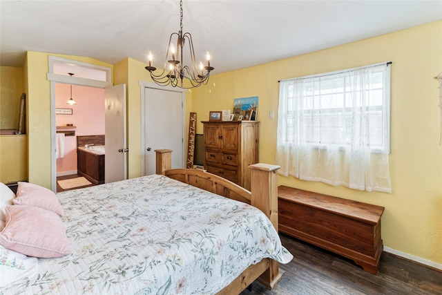 bedroom with ensuite bathroom, baseboards, a notable chandelier, lofted ceiling, and wood finished floors