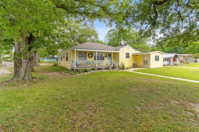 bungalow-style home with a front yard and covered porch