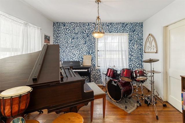 interior space featuring wood finished floors and wallpapered walls