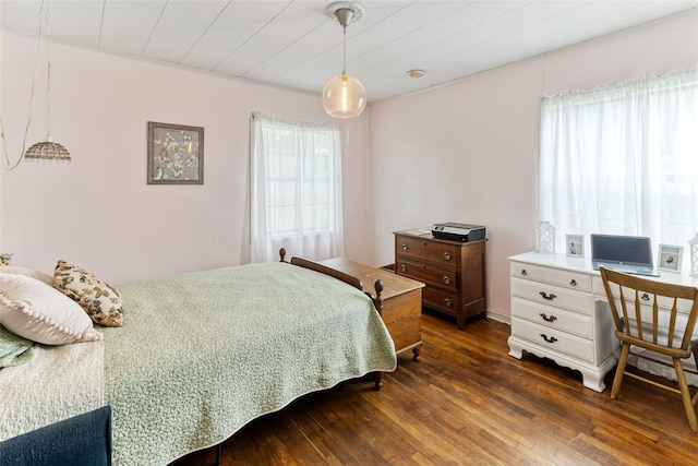 bedroom with dark wood-style floors
